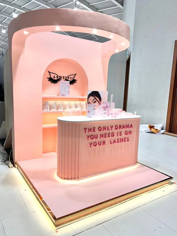 Front view of the Lashtific booth with its base lighting on