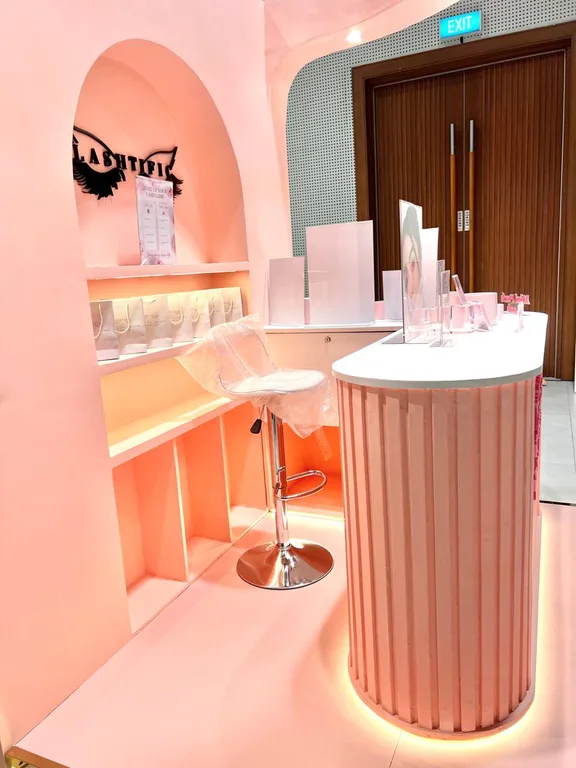 Inside corner of the Lashtific booth with product shelving