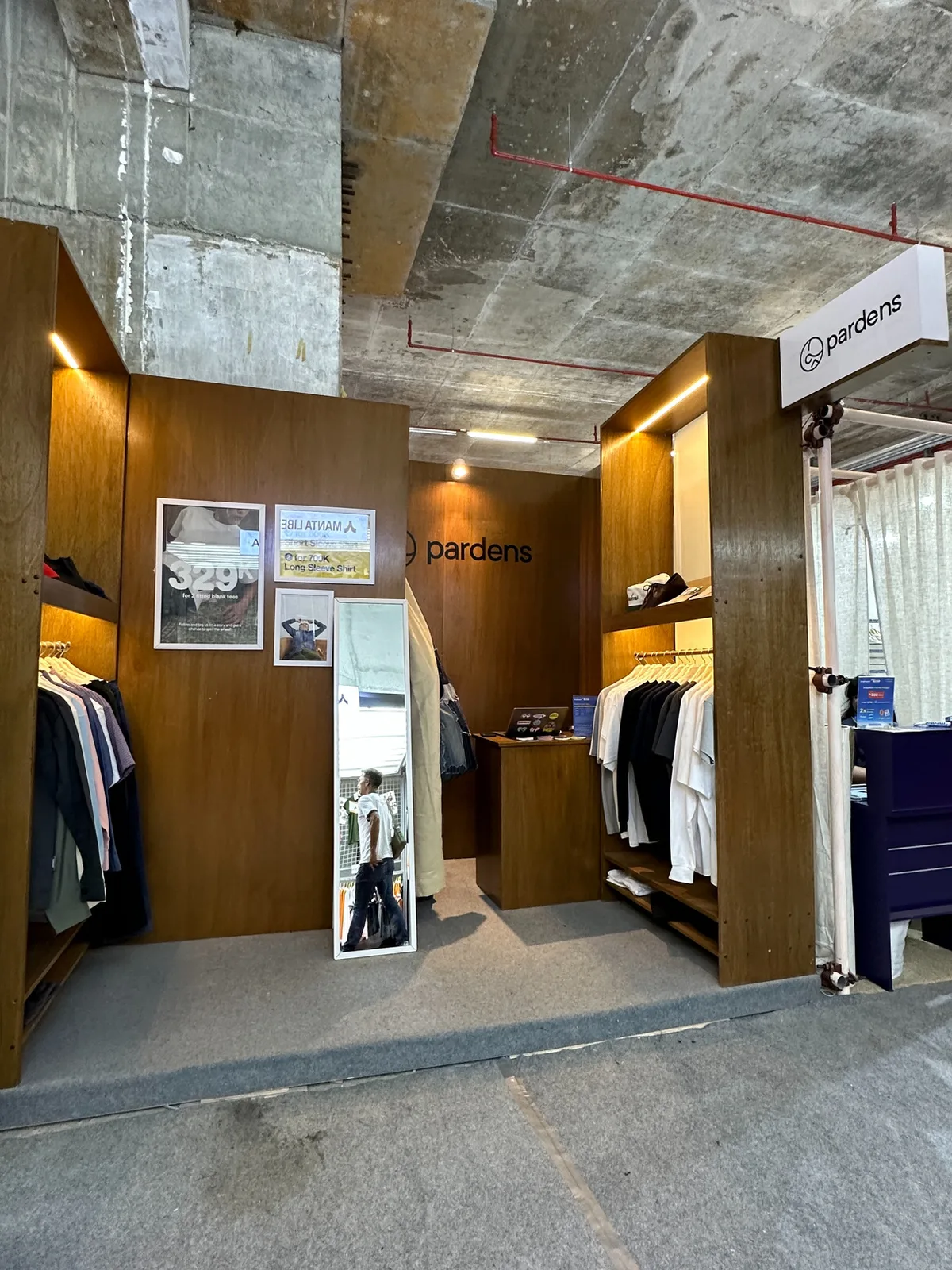 Side of the Pardens booth with garment rails